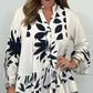 V-neck top with floral print, flared sleeves, and ruffle hem. Spring offer – 49% off