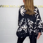 V-neck top with floral print, flared sleeves, and ruffle hem. Spring offer – 49% off