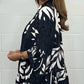 V-neck top with floral print, flared sleeves, and ruffle hem. Spring offer – 49% off